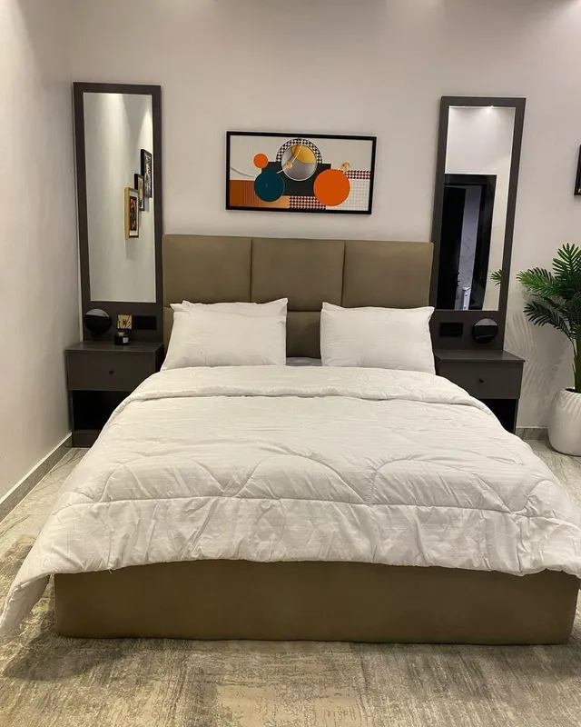 Bedroom with made bed and window light